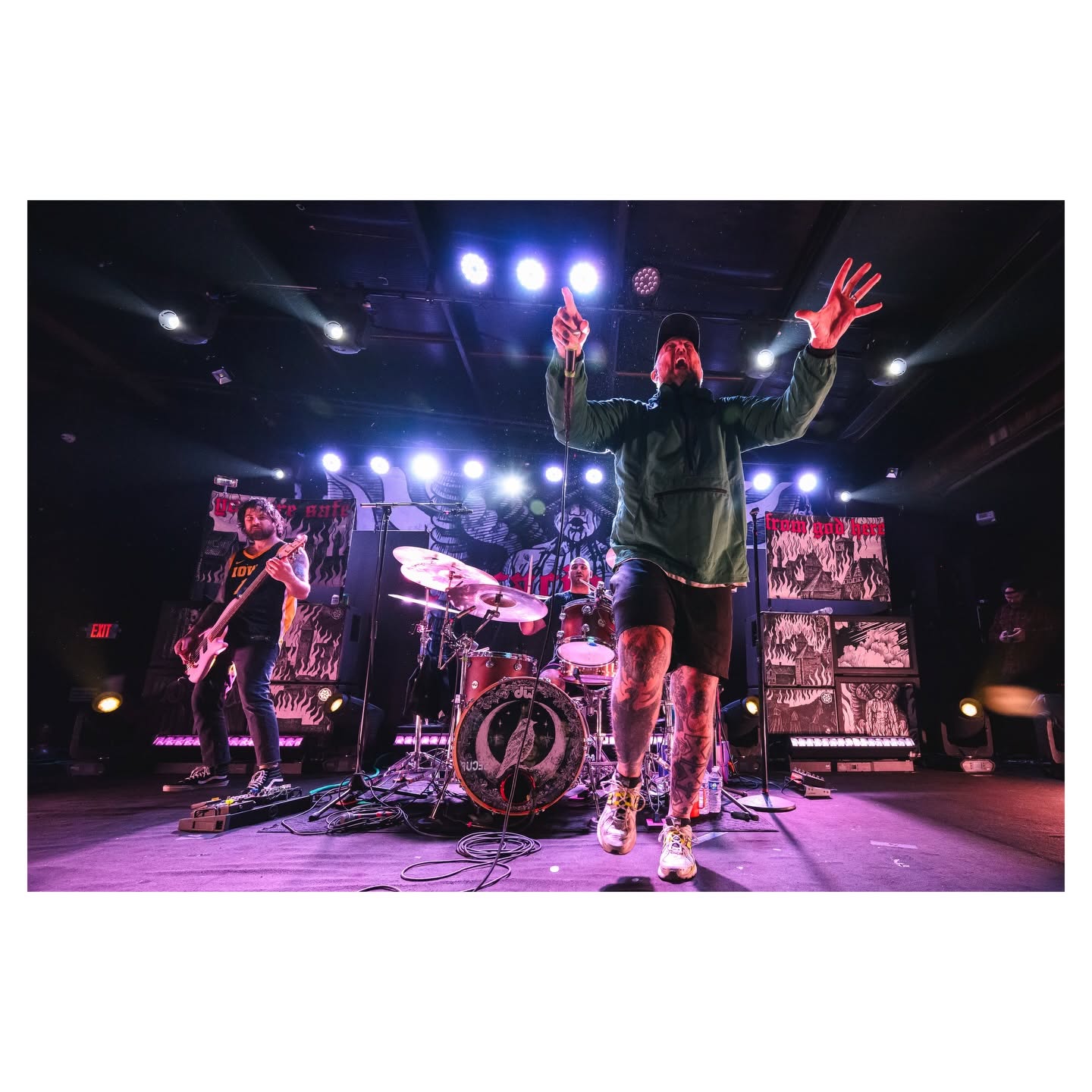 Band performing together beneath bright stage lighting