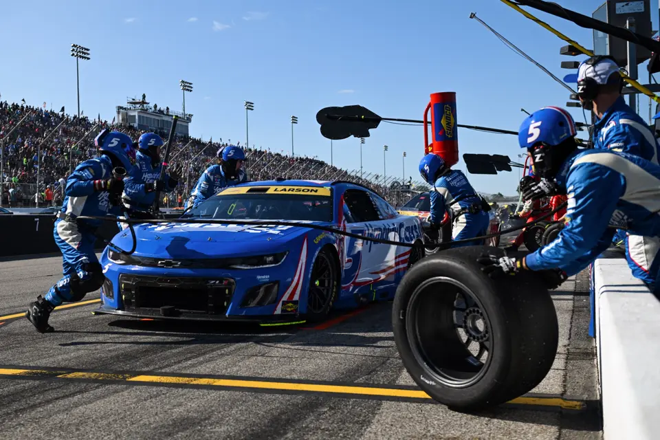 NASCAR pit crew servicing a race car during a pit stop