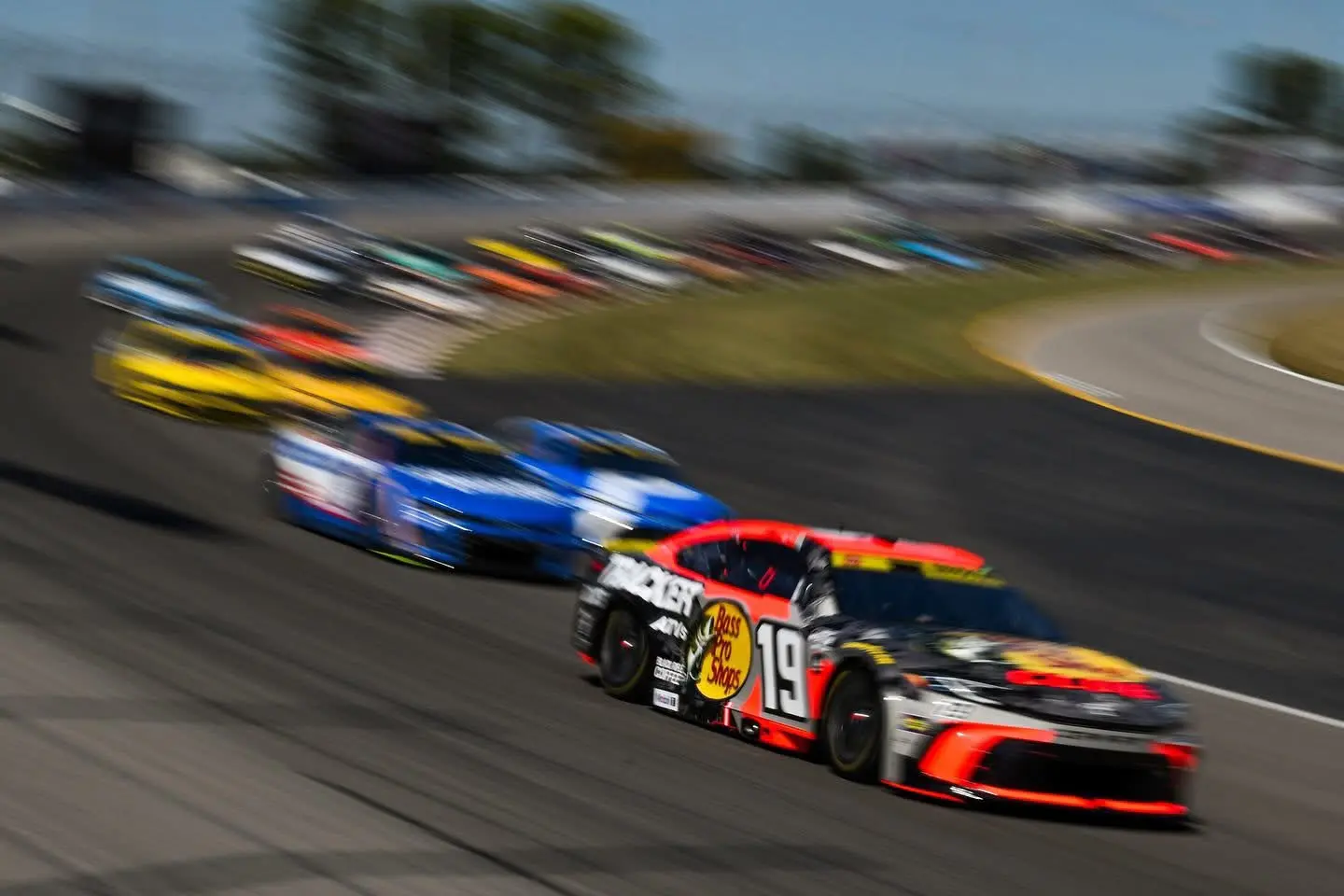 Number 19 NASCAR race car captured with motion blur in a panning photograph