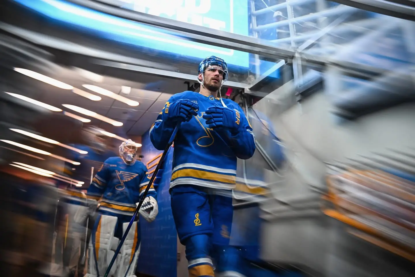 St. Louis Blues player emerging from the arena tunnel with intentional motion blur
