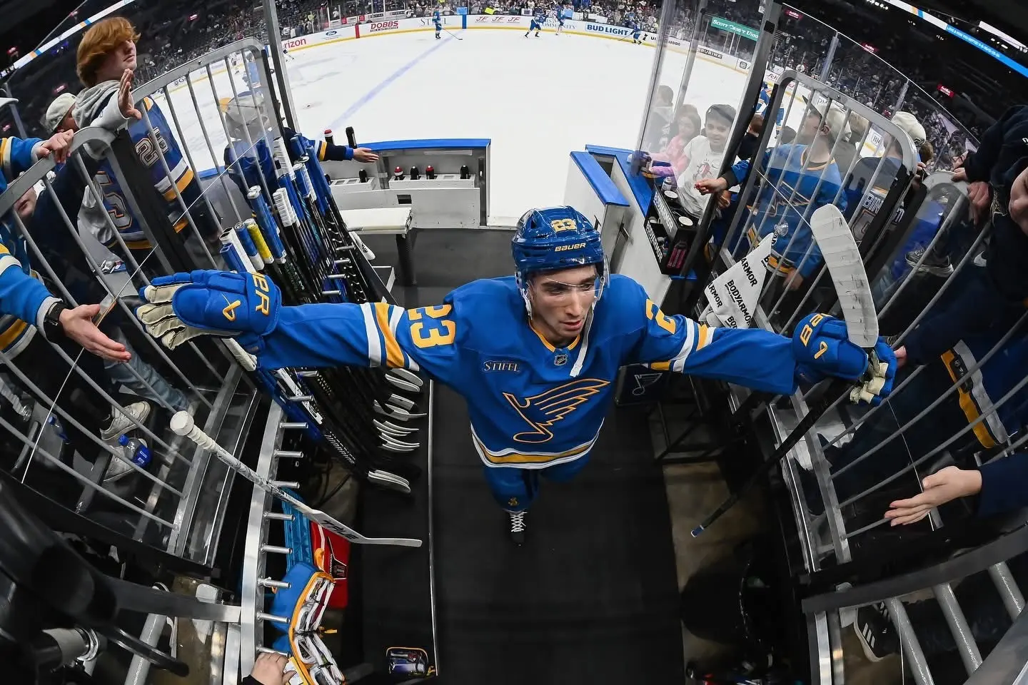 St. Louis Blues player greeting fans while leaving the ice