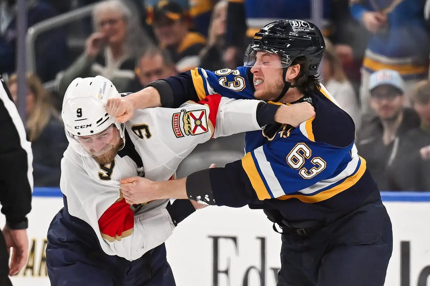 Professional hockey players exchanging punches during a fight